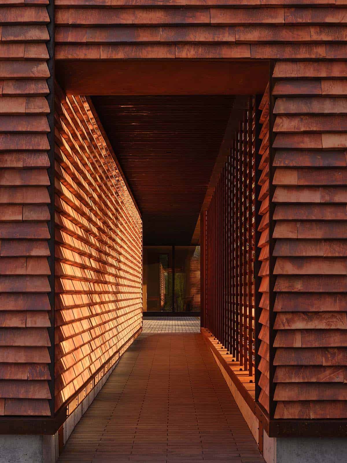 Covered breezeway passage framed by cedar shingles and cedar louvered screen
