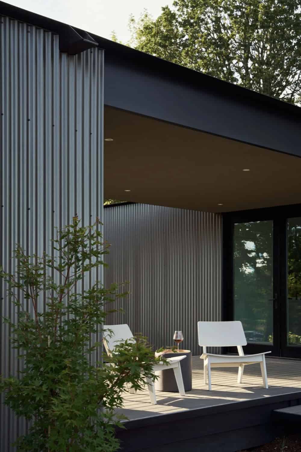 Covered deck corner with lounge chairs and corrugated siding detail