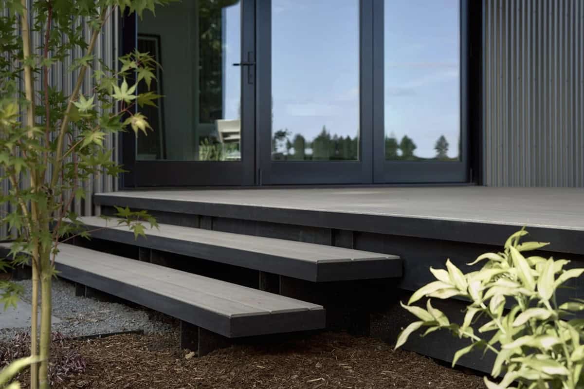 Floating wood steps leading up to glass sliding doors