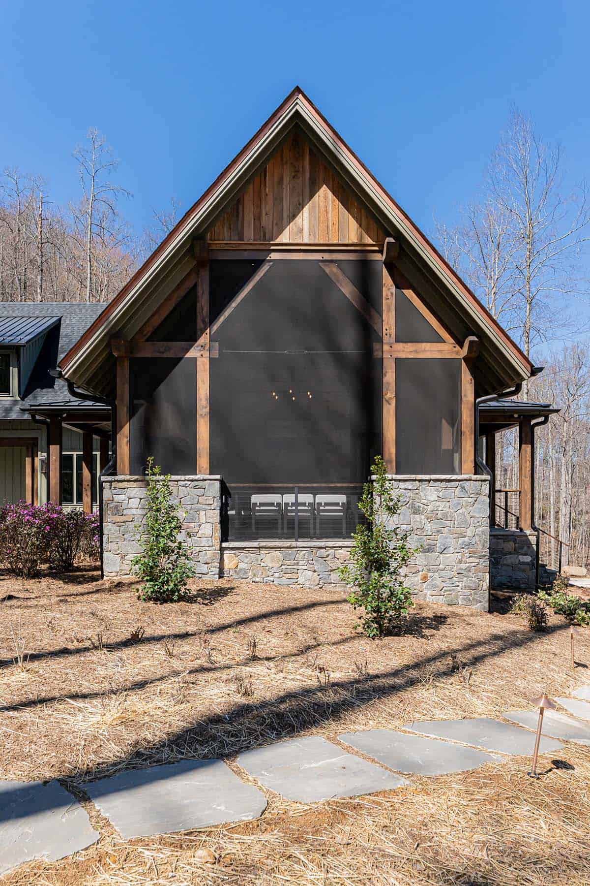 Screened grilling porch with timber frame gable and fireplace