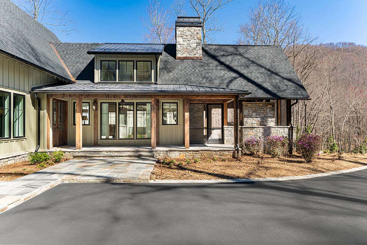 Covered front porch with timber columns and stone chimney