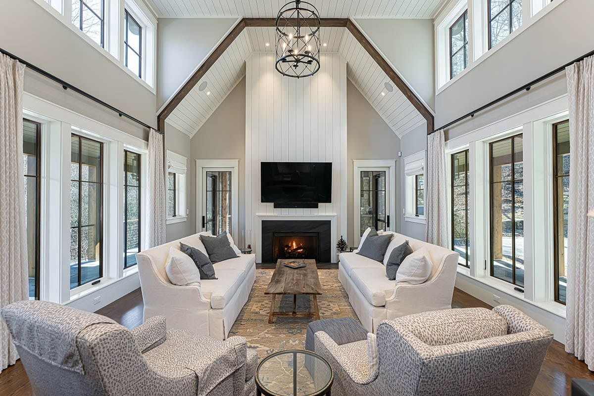 Living room with vaulted shiplap ceiling and stone fireplace