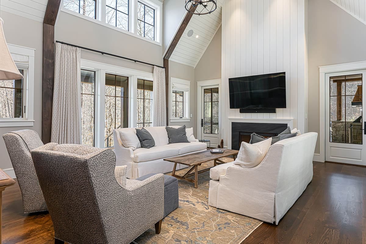 Living room seating area with TV above stone fireplace