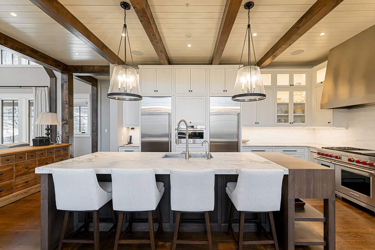 Kitchen island with bar stools and double refrigerator wall