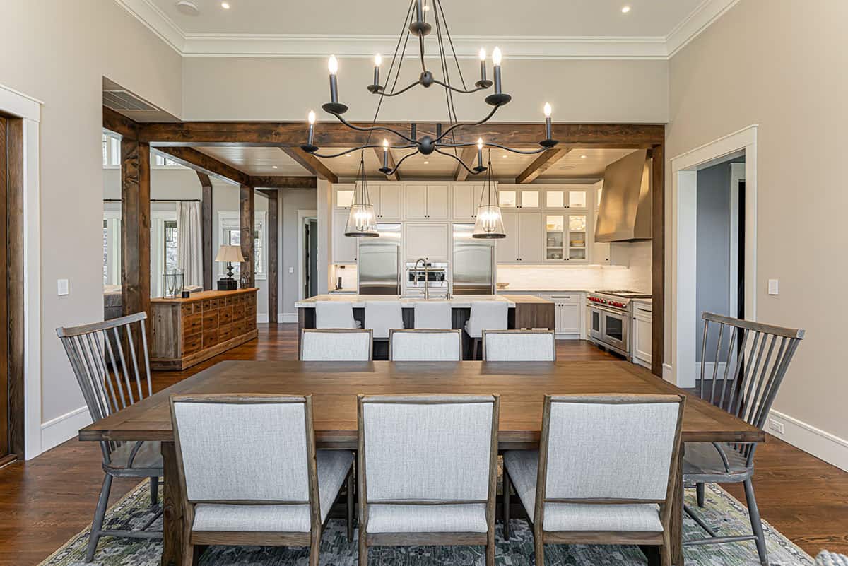 Dining area with iron chandelier and view into kitchen