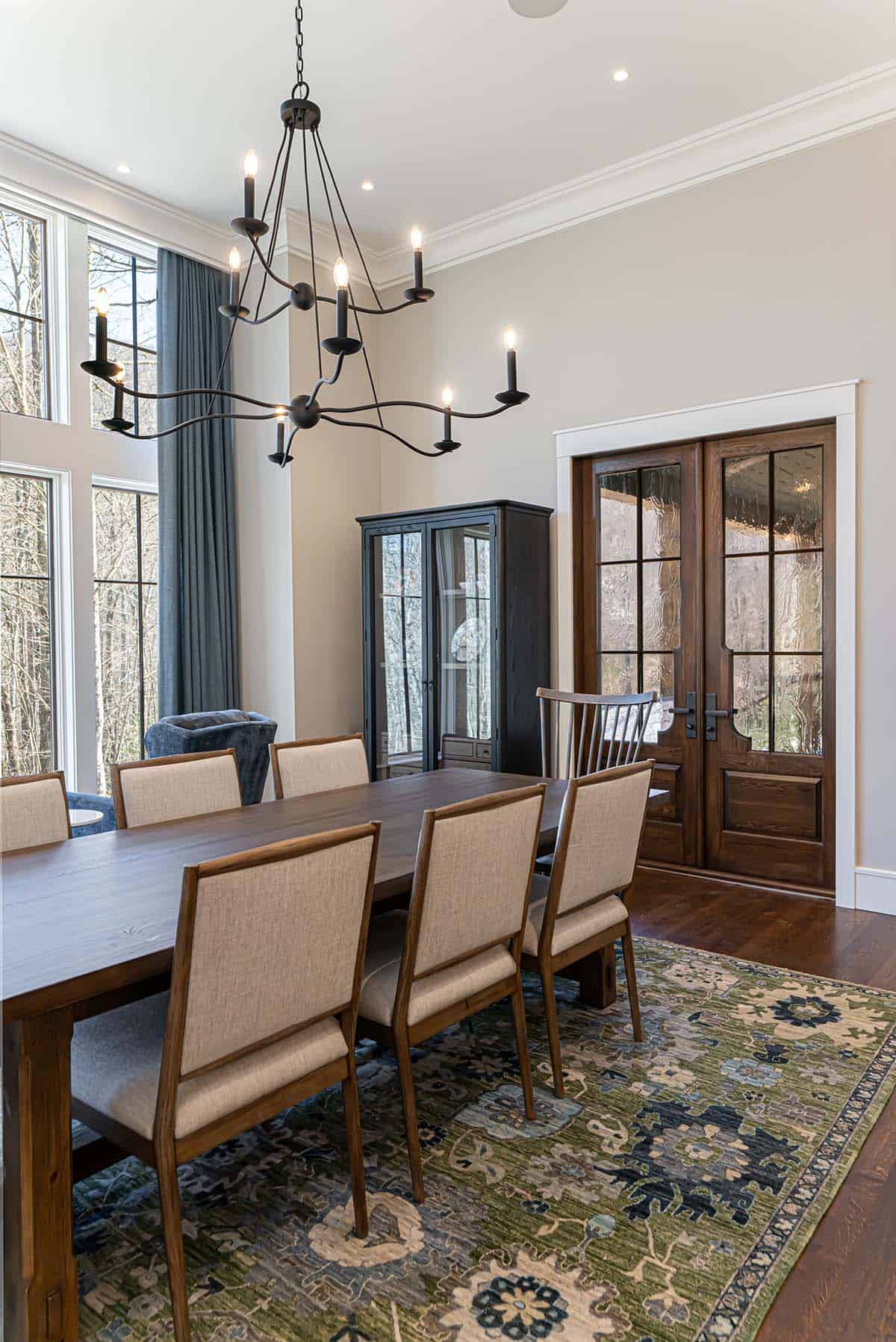 Dining room with iron chandelier and antique display cabinet