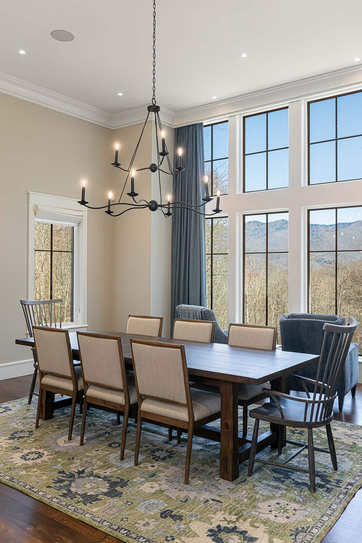 Dining table with floor-to-ceiling windows and mountain views