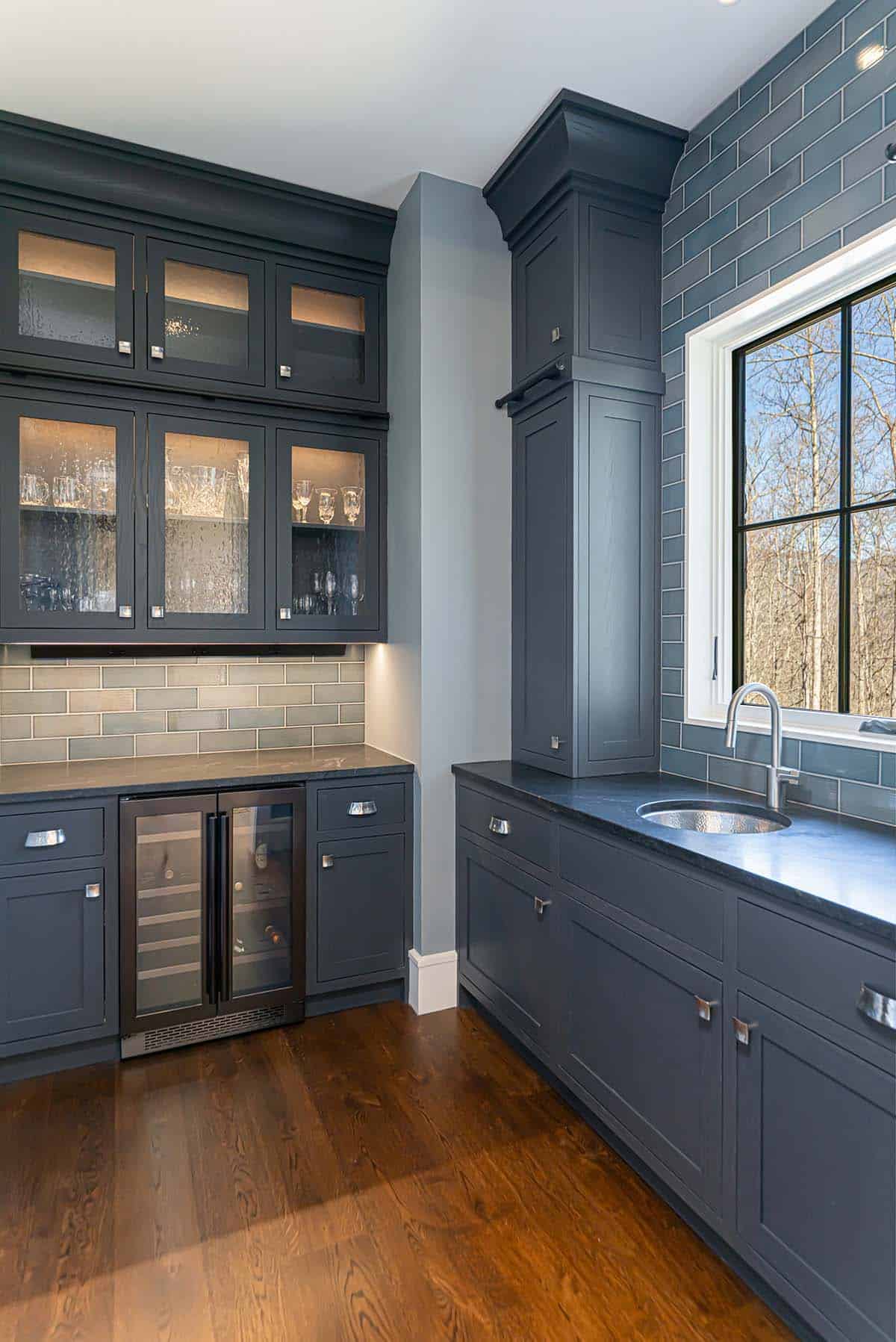 Wet bar with glass cabinets and built-in wine fridge