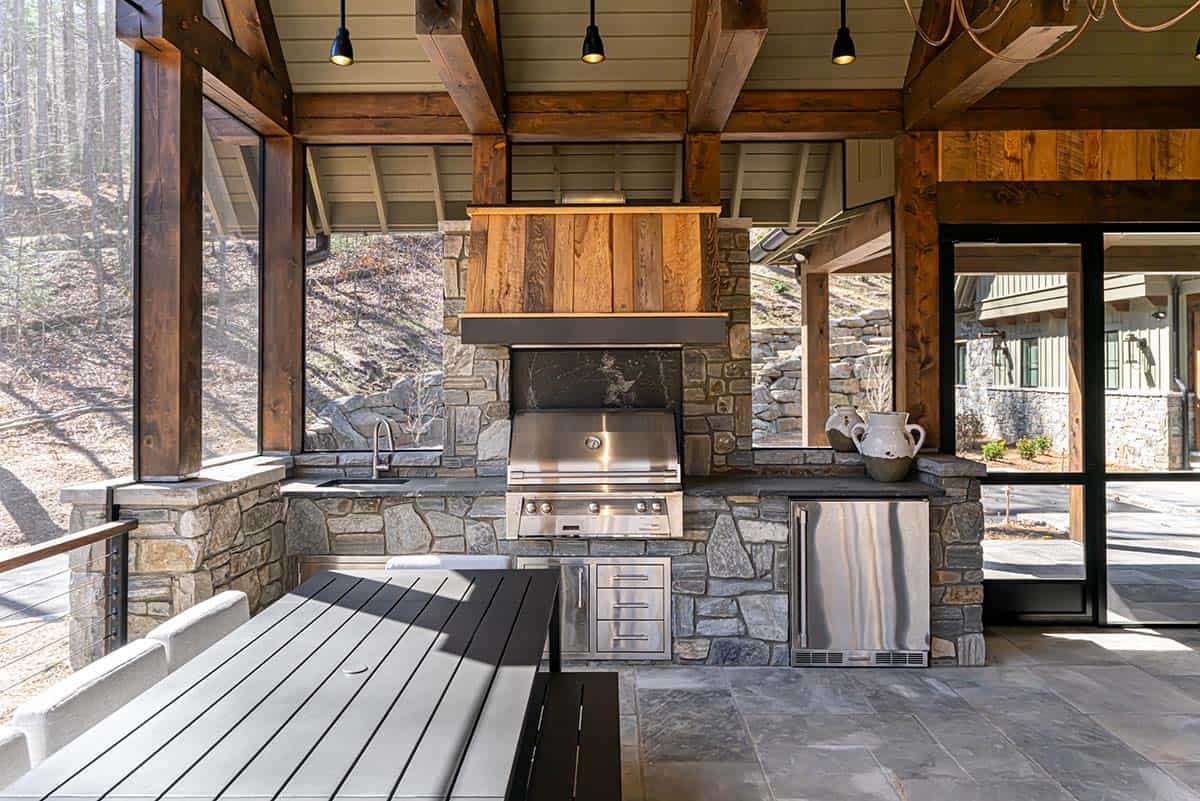 Outdoor kitchen with stainless grill and cedar hood