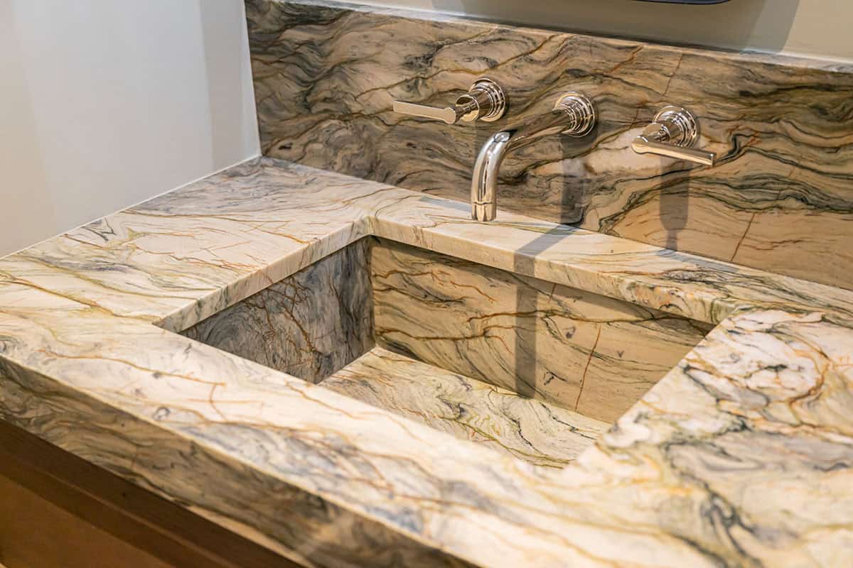 Marble vanity sink detail with polished nickel fixtures