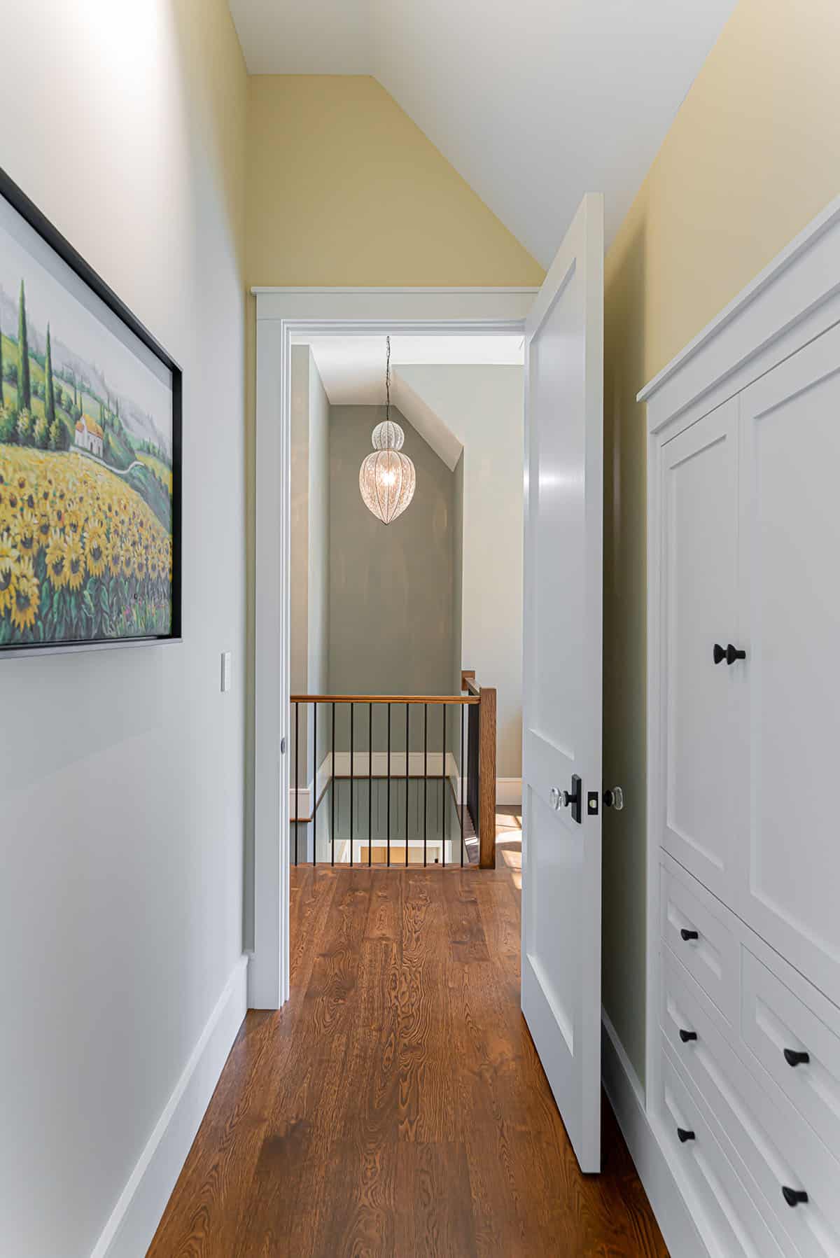 Hallway with sunflower painting and view to stairwell