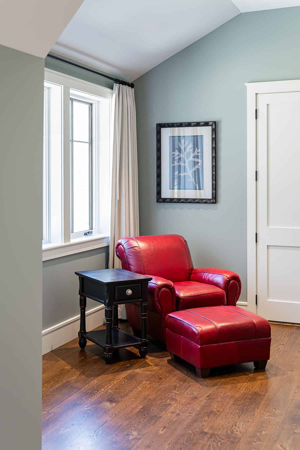 Sitting area with red leather chair and ottoman