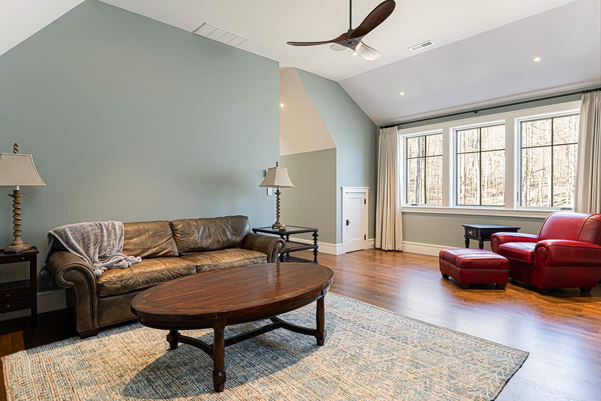 Bonus room with leather sofa and red leather chair