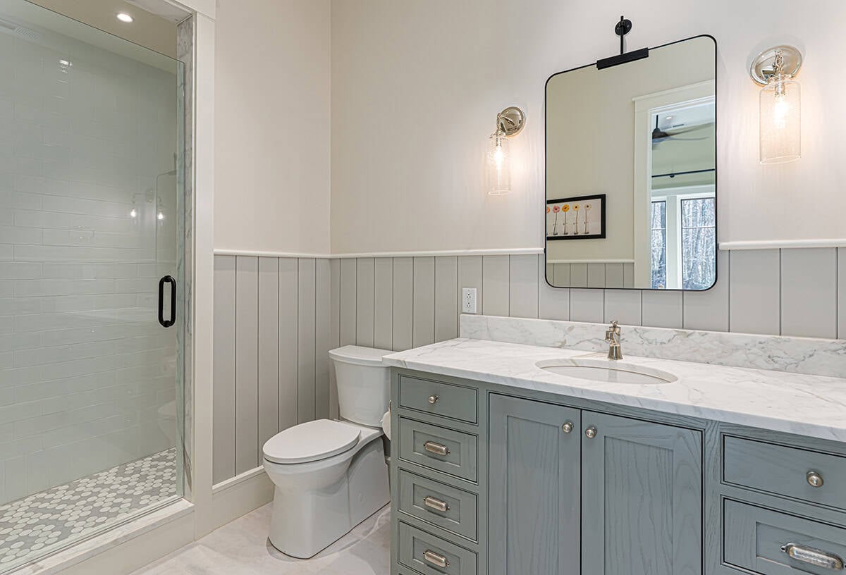 Bathroom with gray vanity and walk-in glass shower