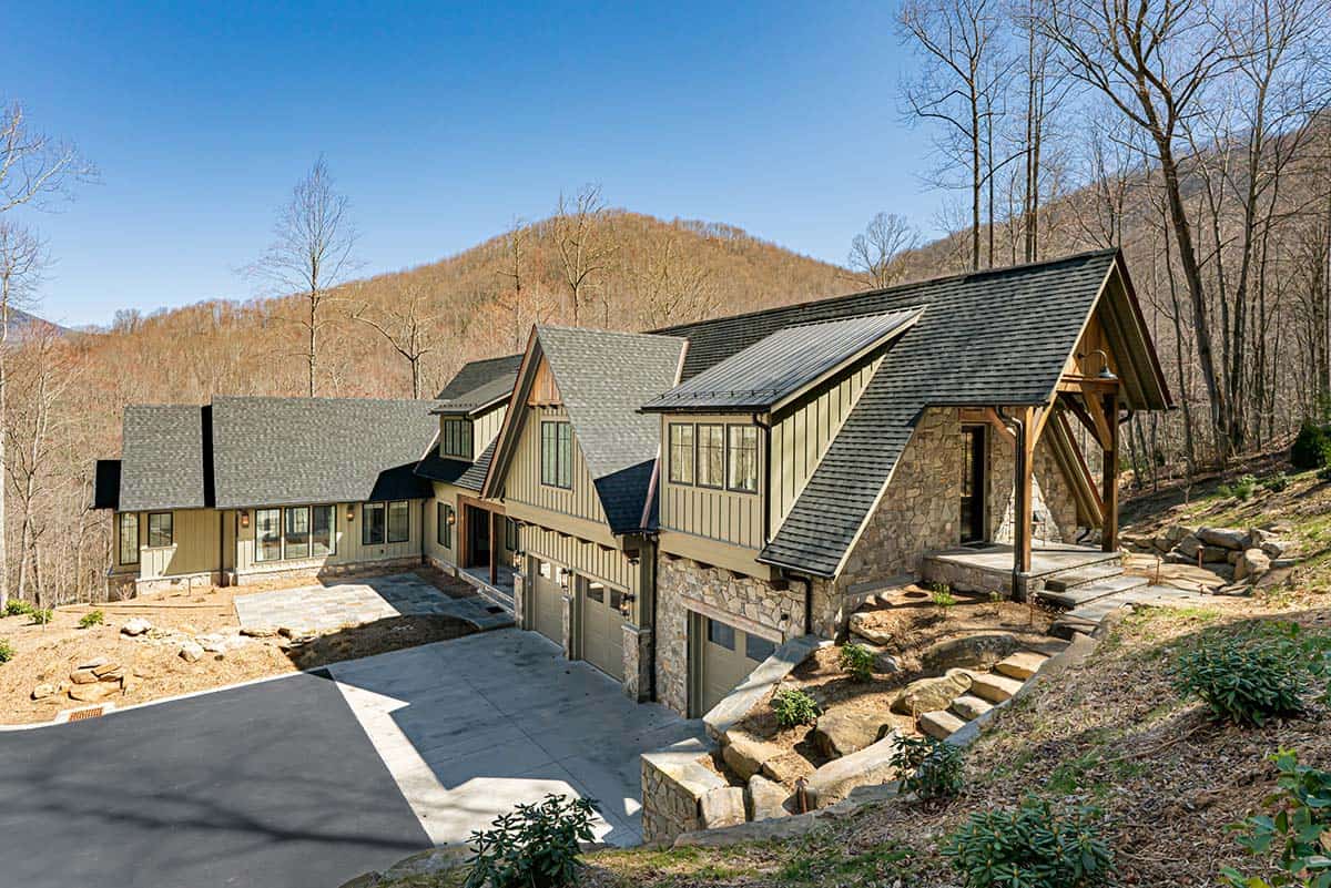 Mountain home exterior with stone screened porch and forest views