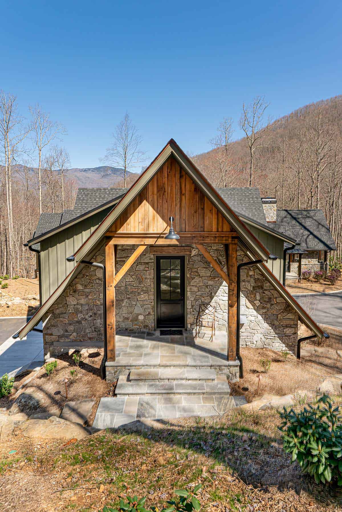 Guest suite stone exterior with timber porch and gabled roof