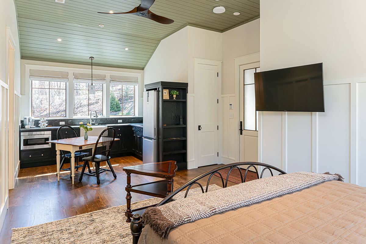 Guest suite bedroom open to kitchenette with green ceiling