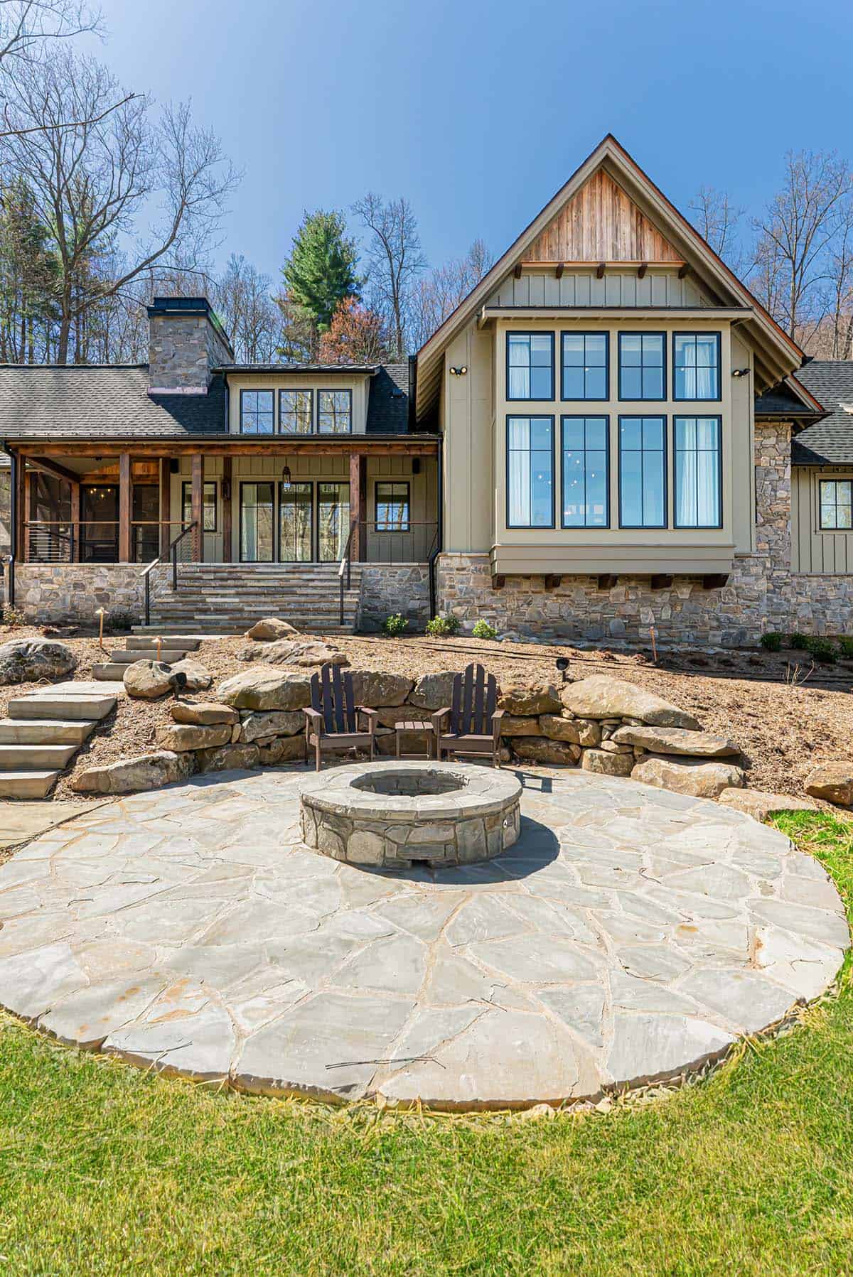 Backyard fire pit patio with stone retaining wall and home exterior