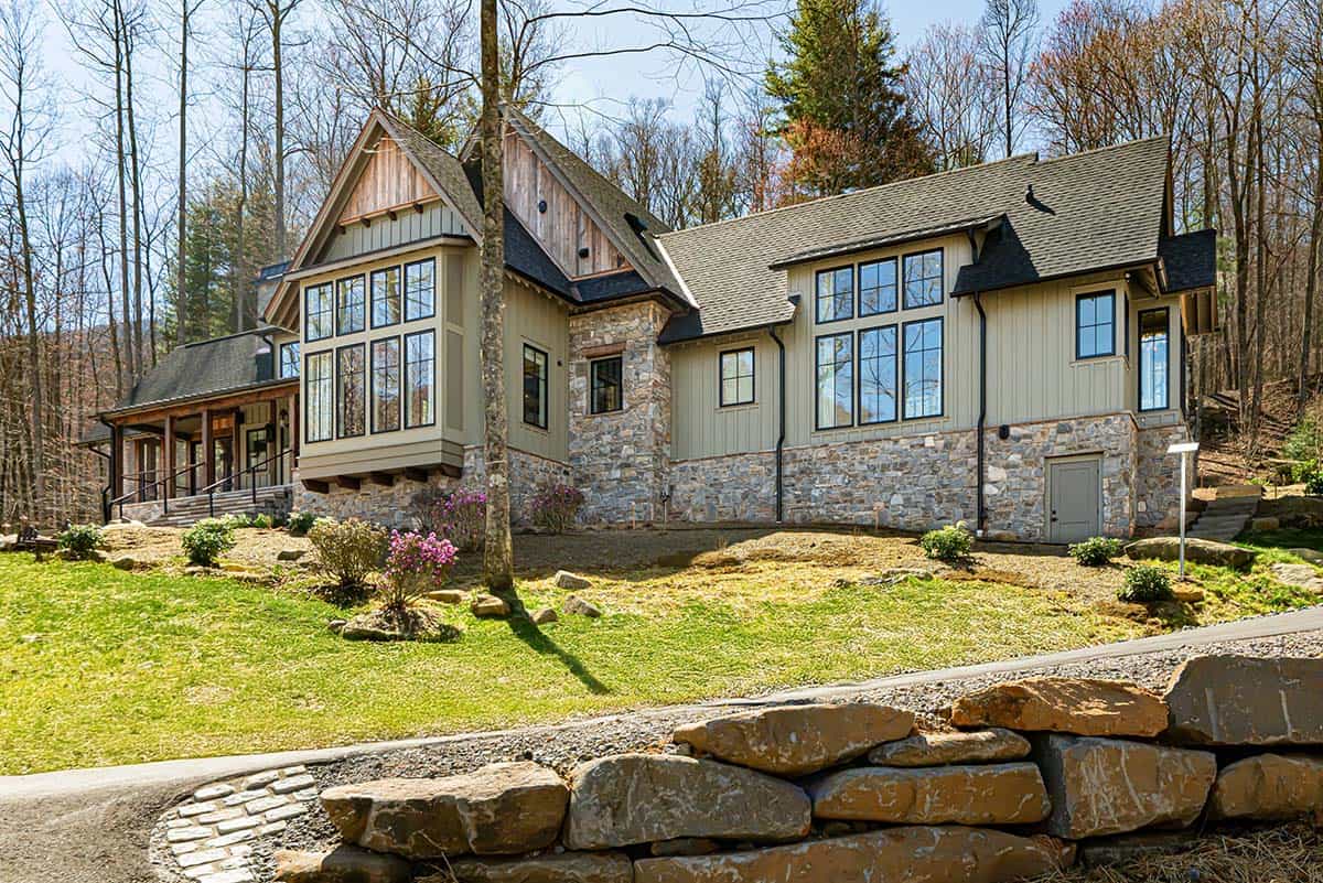 Side exterior with stone foundation and large picture windows