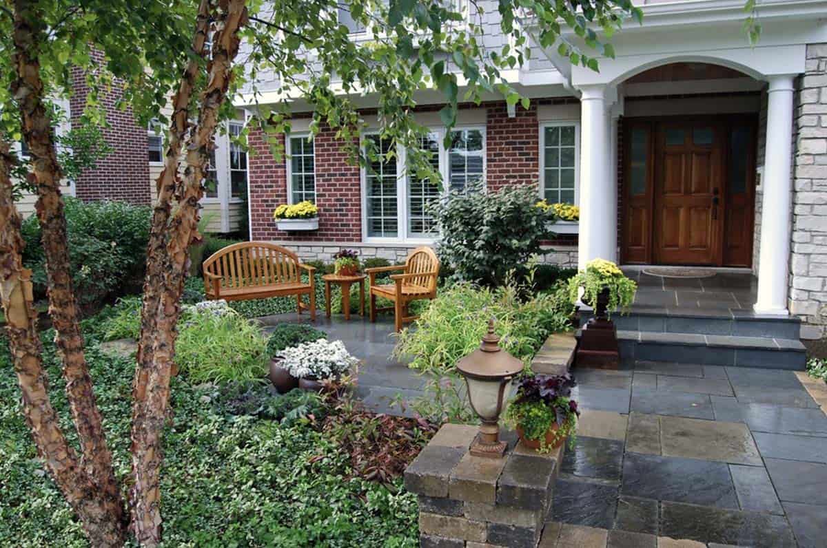 Small front garden seating area with river birch tree and bluestone patio at a Chicago home