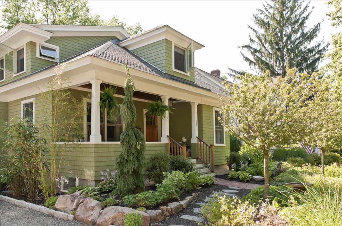 Weeping cypress tree flanking the entry path at a Craftsman home in Boston, MA