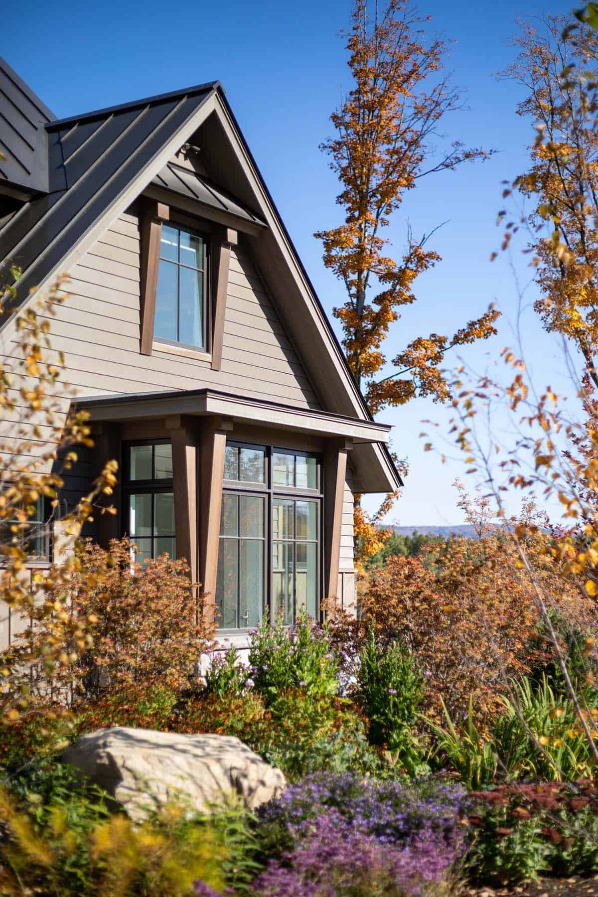 Craftsman-style gable dormer with timber bracket window surrounds