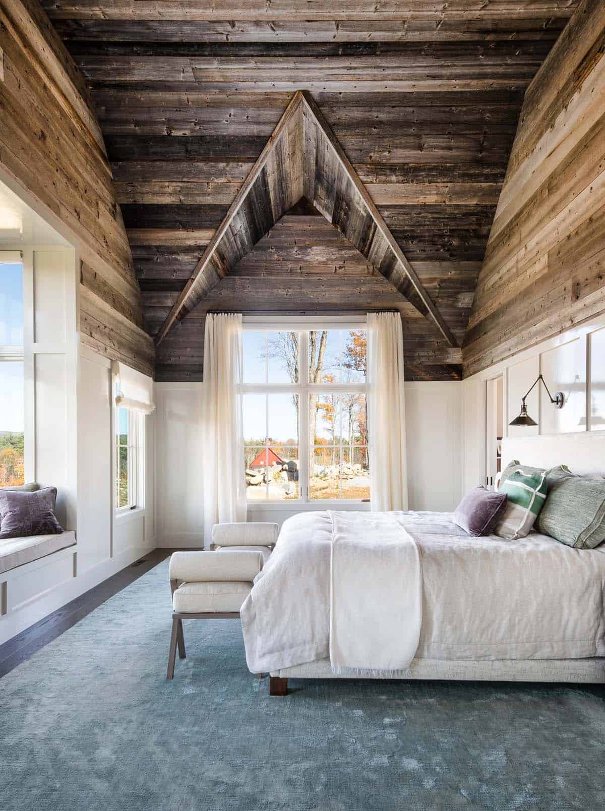 Primary bedroom with reclaimed barnwood vaulted ceiling and window seat