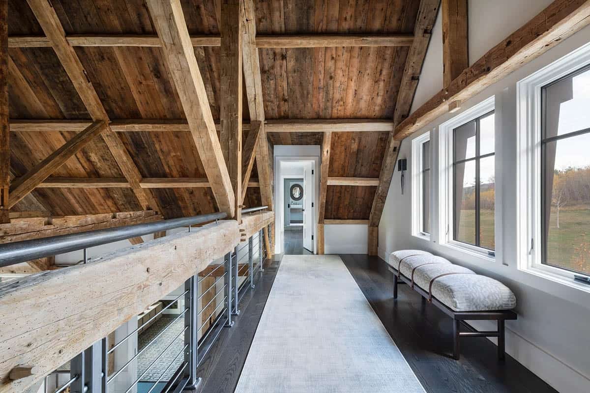 Loft hallway with exposed timber trusses and cable railing