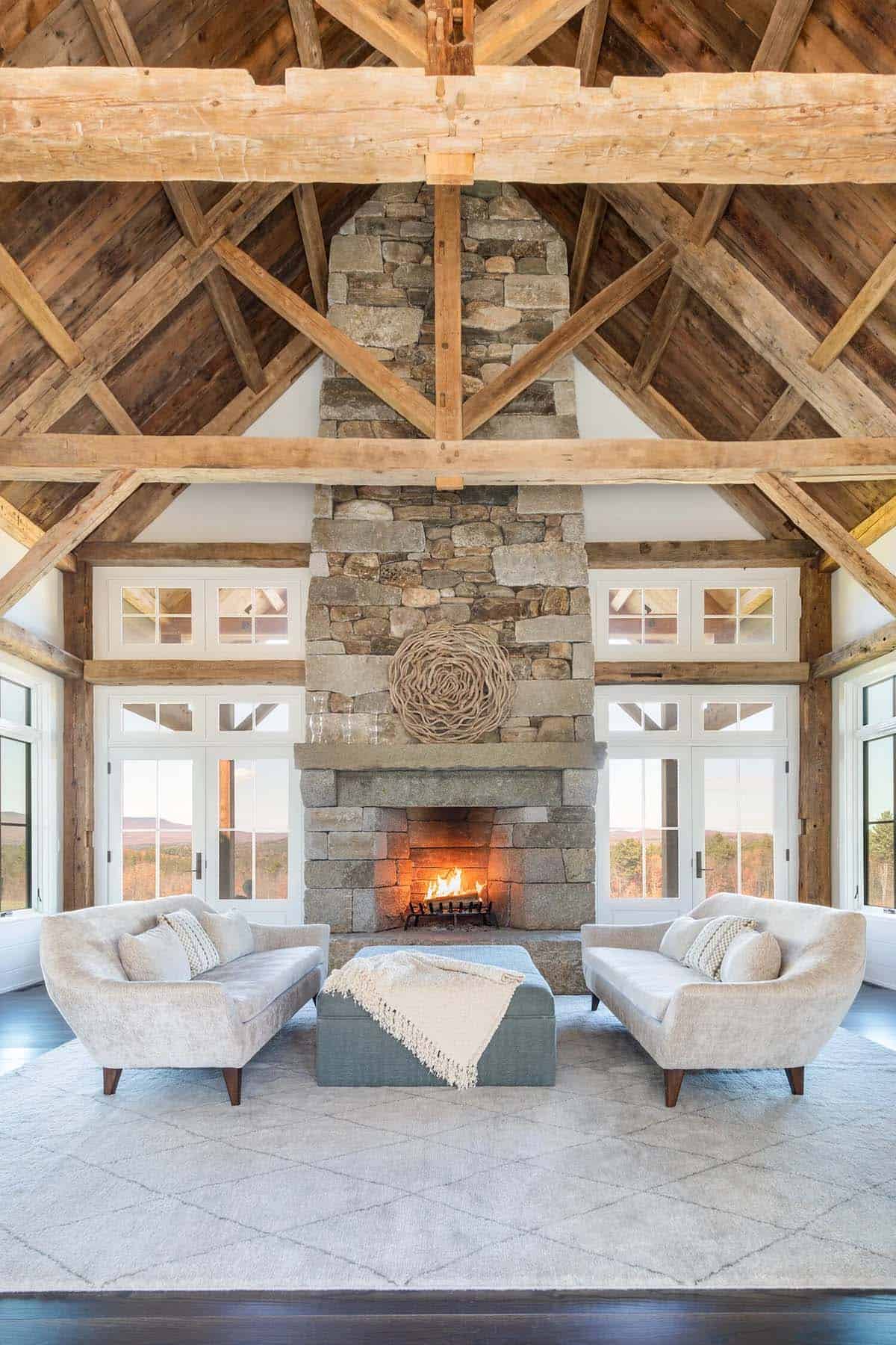 Great room with soaring timber trusses and stone fireplace