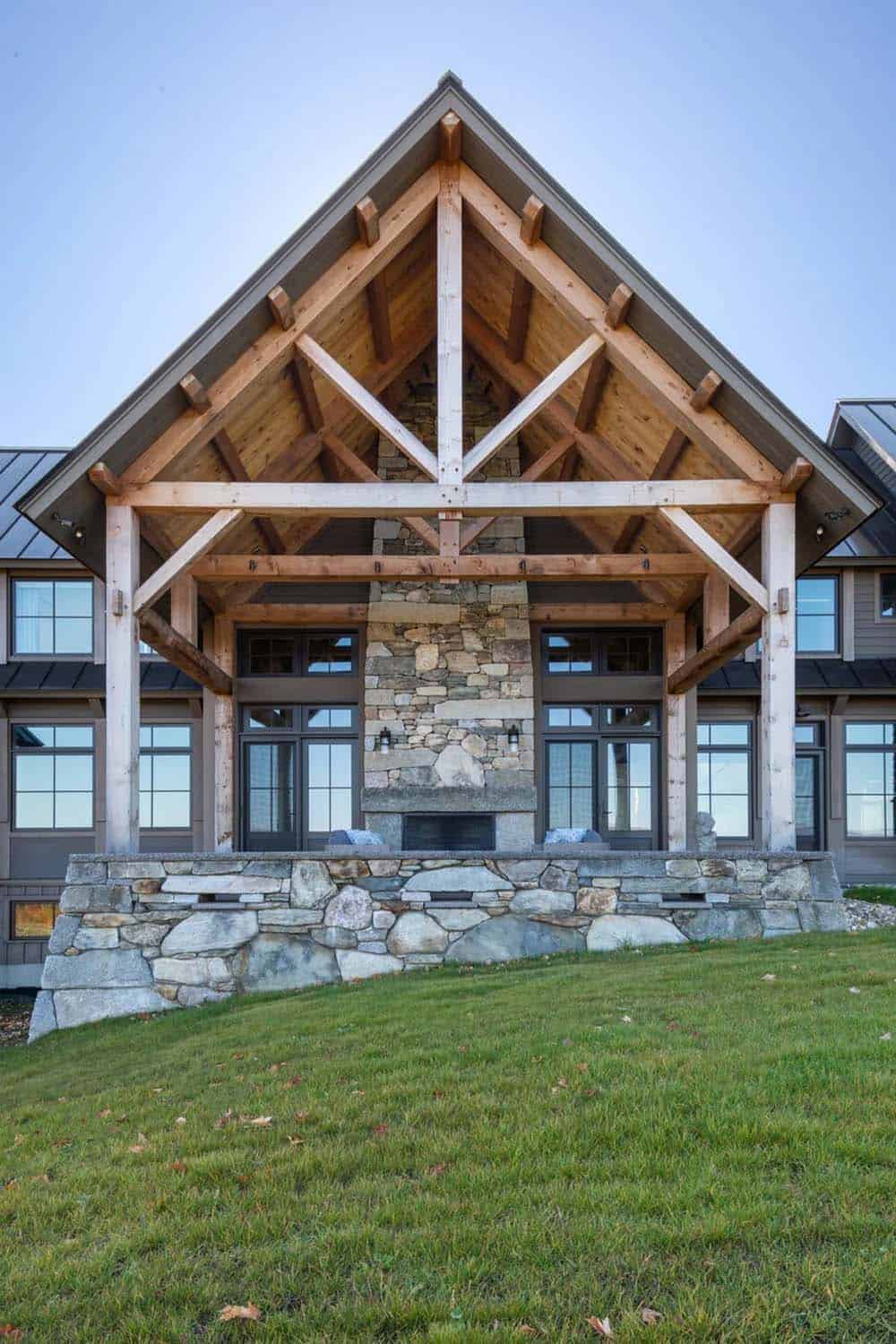 Timber-frame porch gable with stone fireplace and exposed rafters