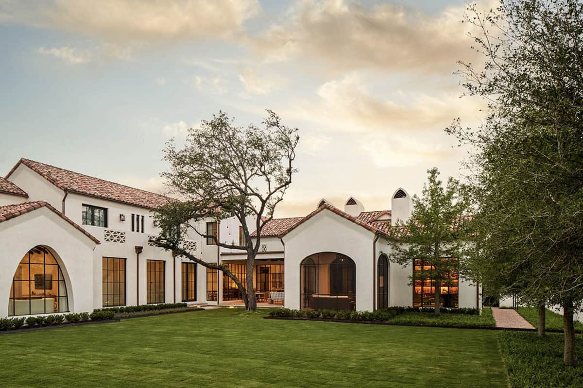 Rear exterior of Spanish Colonial Revival home in Texas with arched steel windows