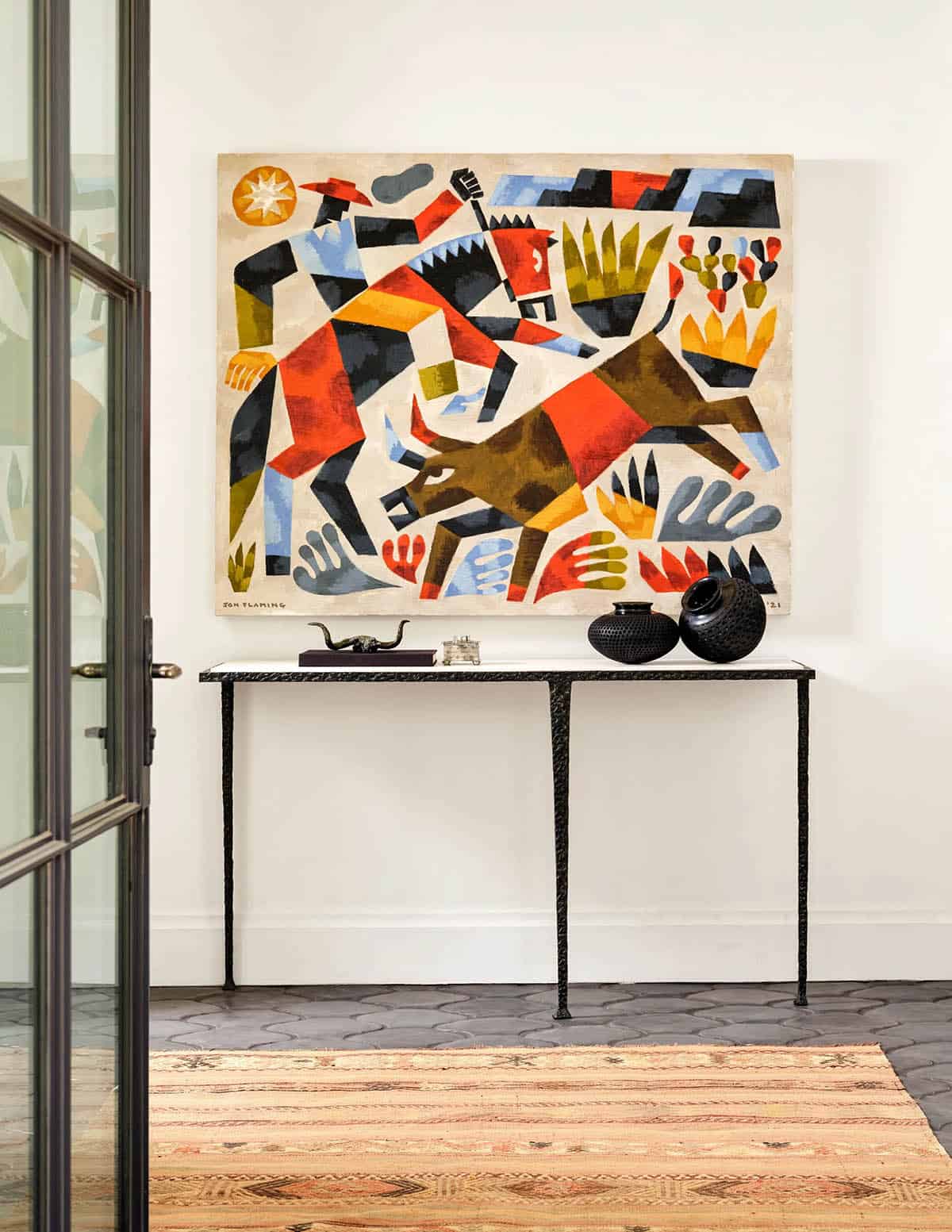 Entryway console table with bold figurative painting in Spanish Colonial Revival home