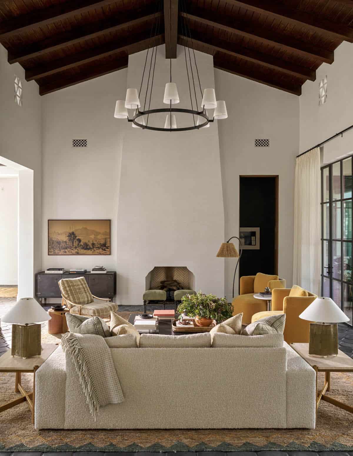 Living room with vaulted wood beam ceiling and mustard velvet chairs