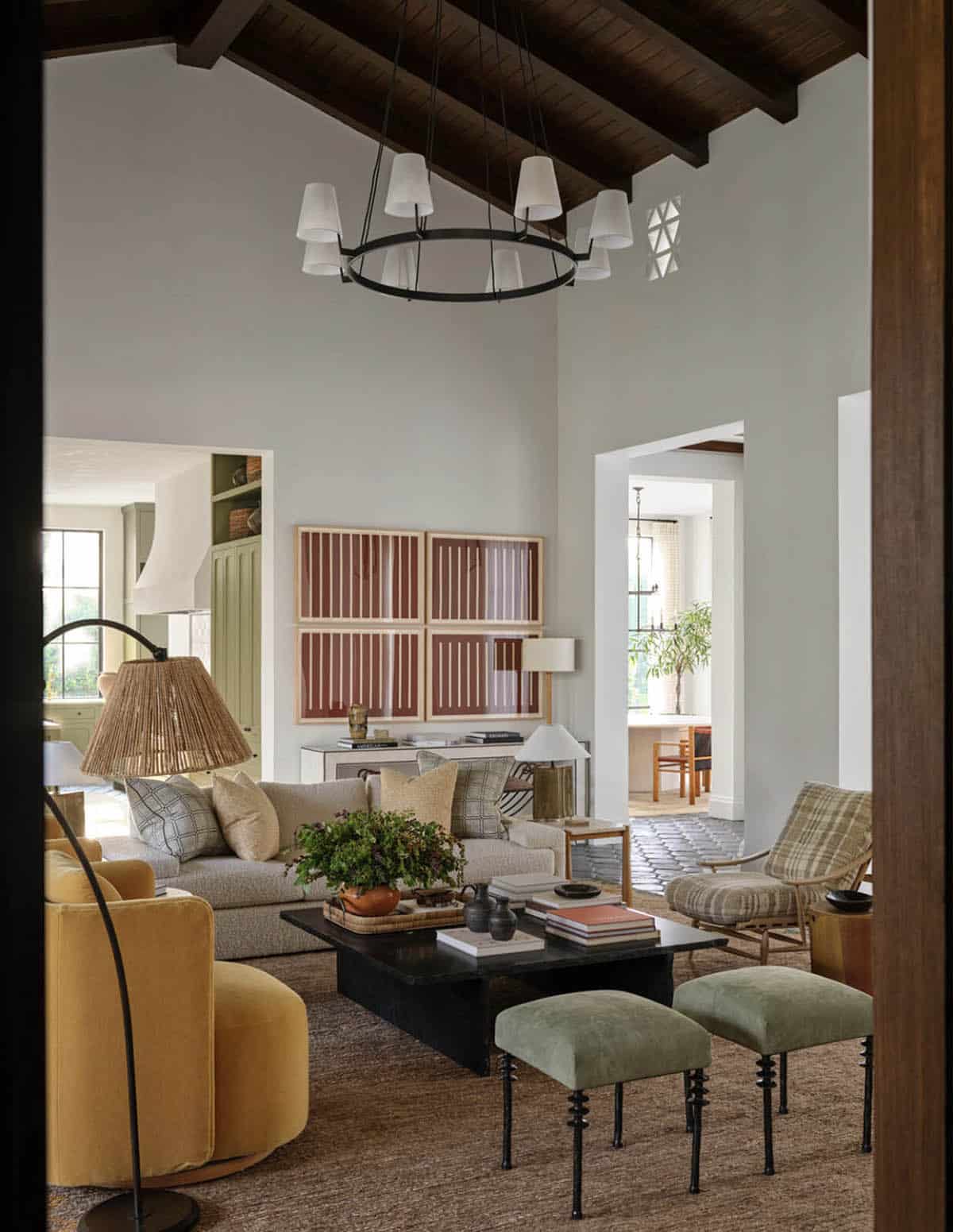 Living room with ring chandelier and graphic framed art above credenza