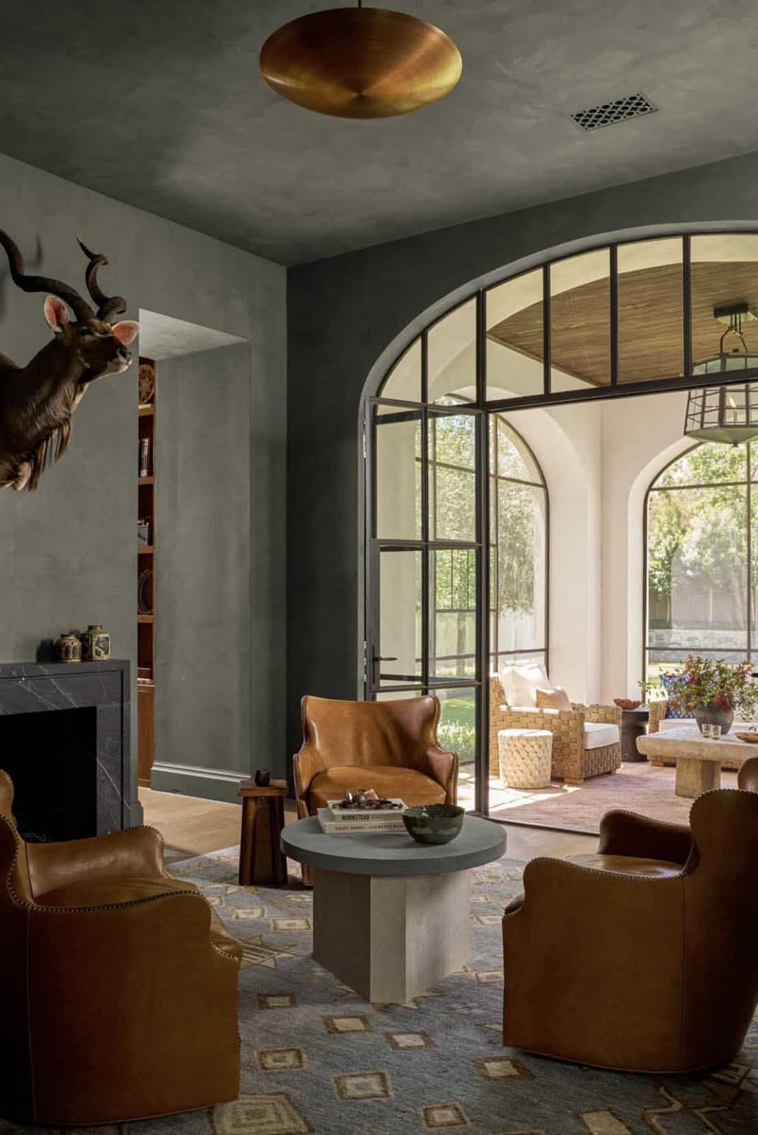 Moody den with leather armchairs and mounted kudu horns
