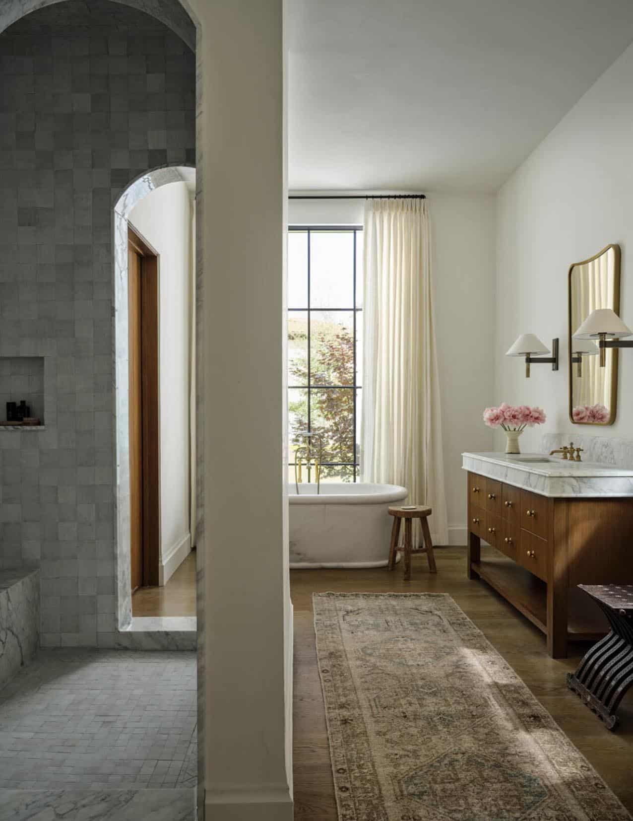 Primary bathroom with freestanding tub and zellige tile shower