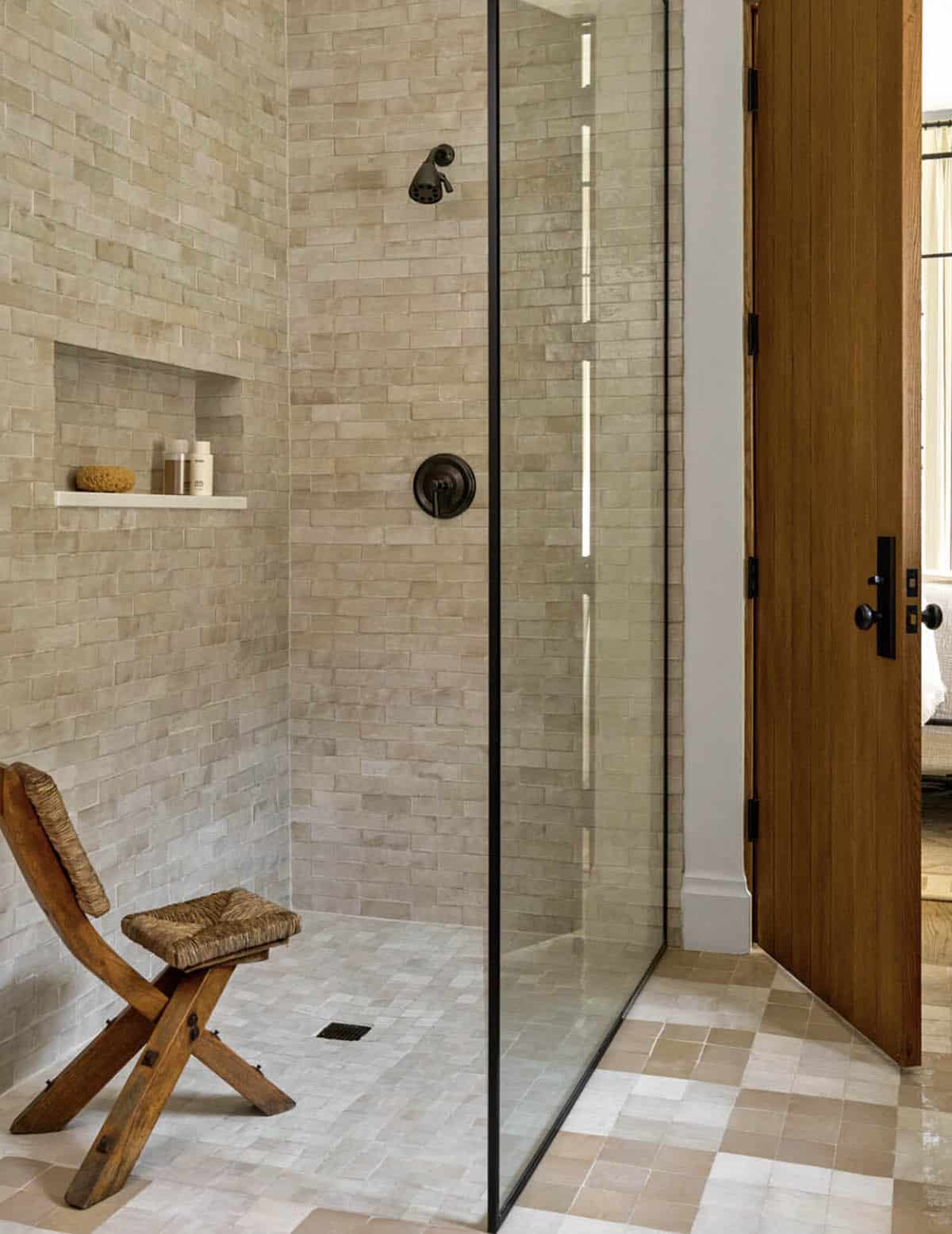 Zellige tile shower with rush chair and walnut door