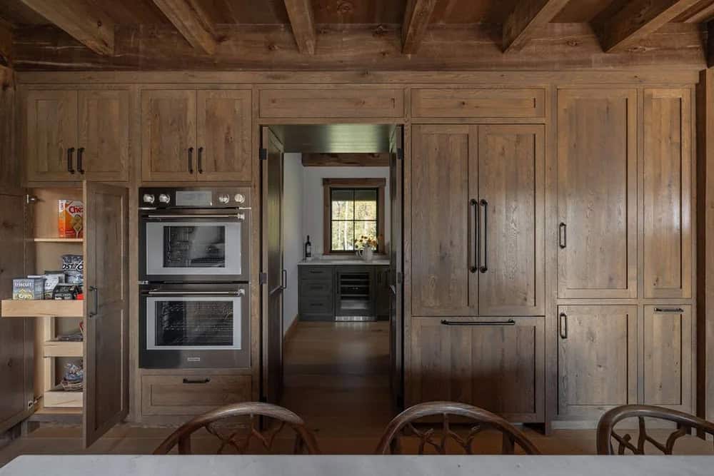 Built-in kitchen cabinetry with double wall ovens and paneled refrigerator