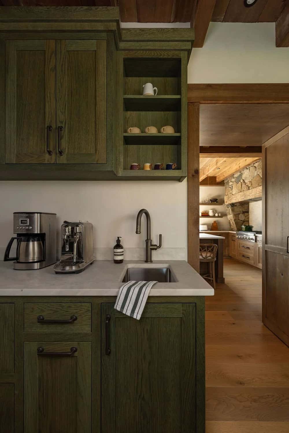Green cabinetry butler's pantry with coffee station and view into kitchen