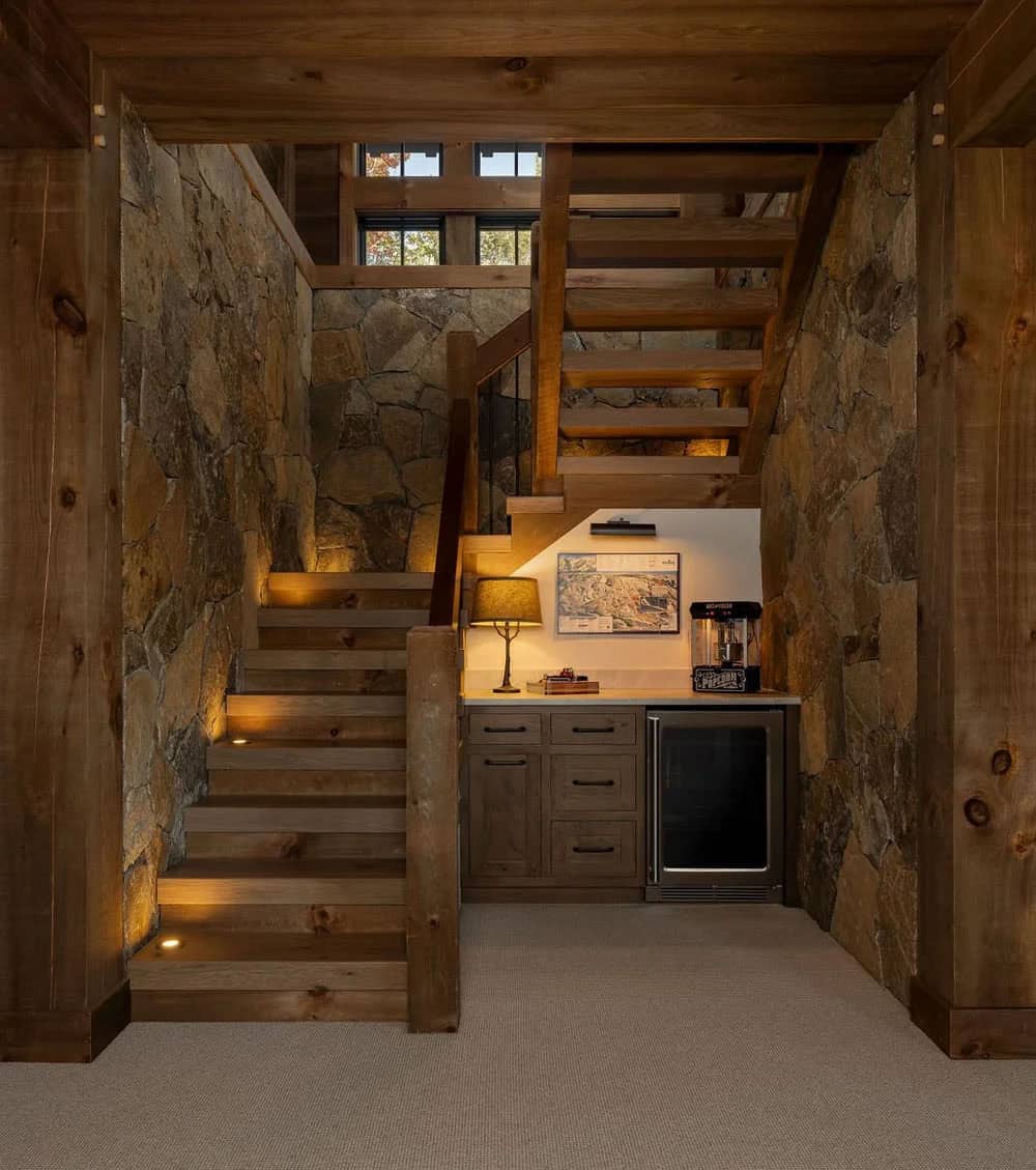 Stone-walled stairwell with built-in bar nook and wine fridge
