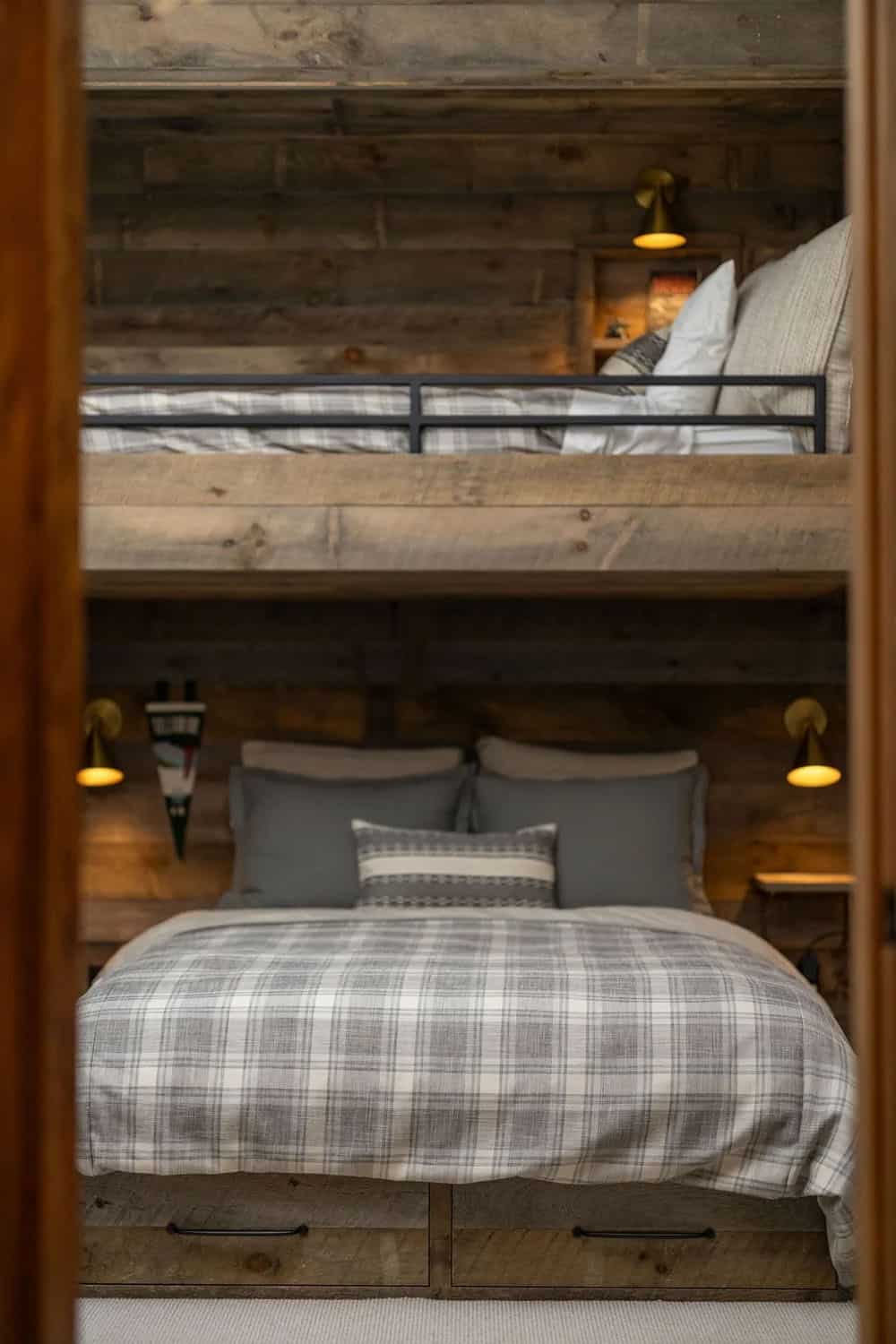 Built-in bunk beds with plaid bedding viewed through doorway