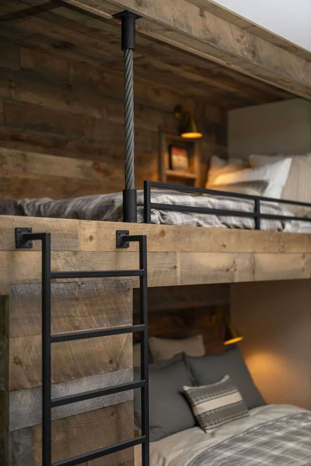 Close-up of rustic bunk bed ladder with cable post and sconce lighting