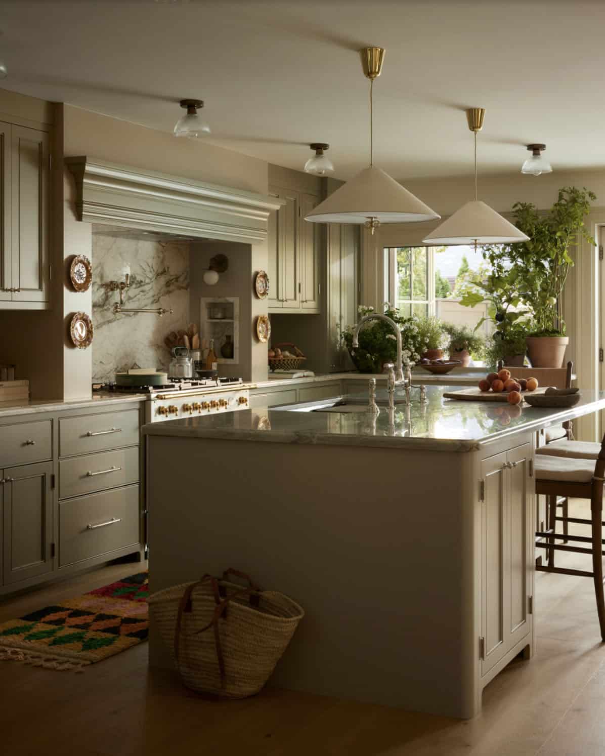 Kitchen island view with brass pendant lights and woven market basket