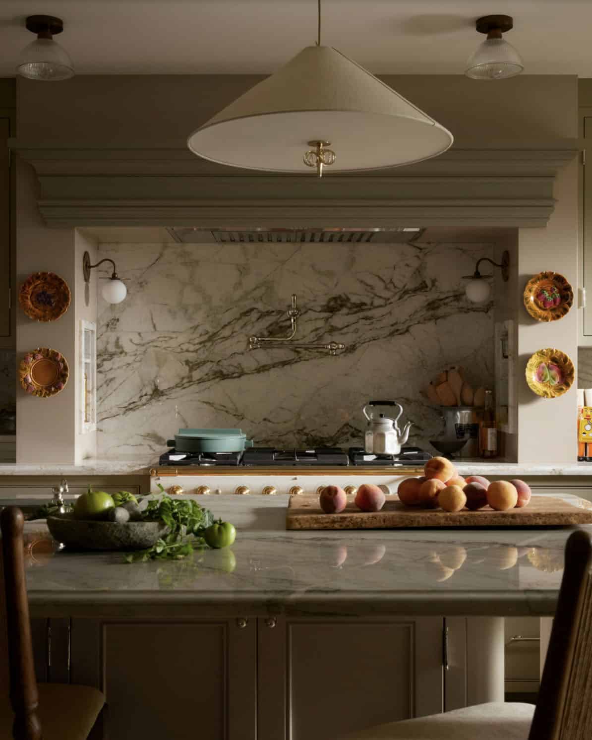 Marble range wall with brass pot filler and cone pendant light