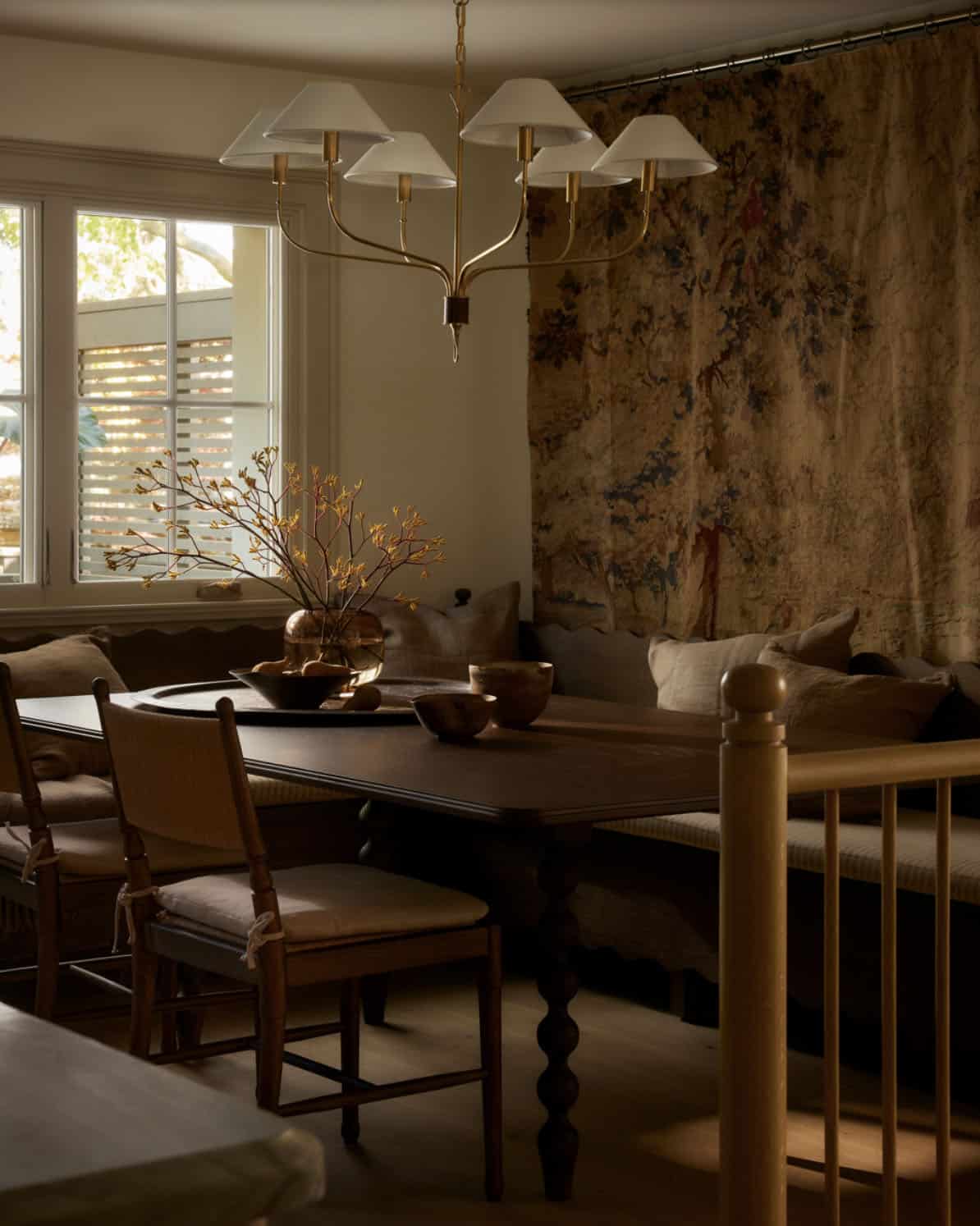 Breakfast banquette with barley-twist table leg and tapestry wall