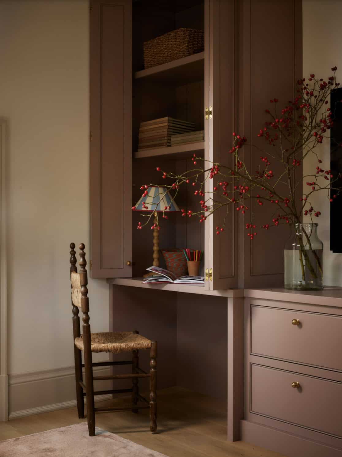 Mauve built-in cabinetry with desk nook and berry branches
