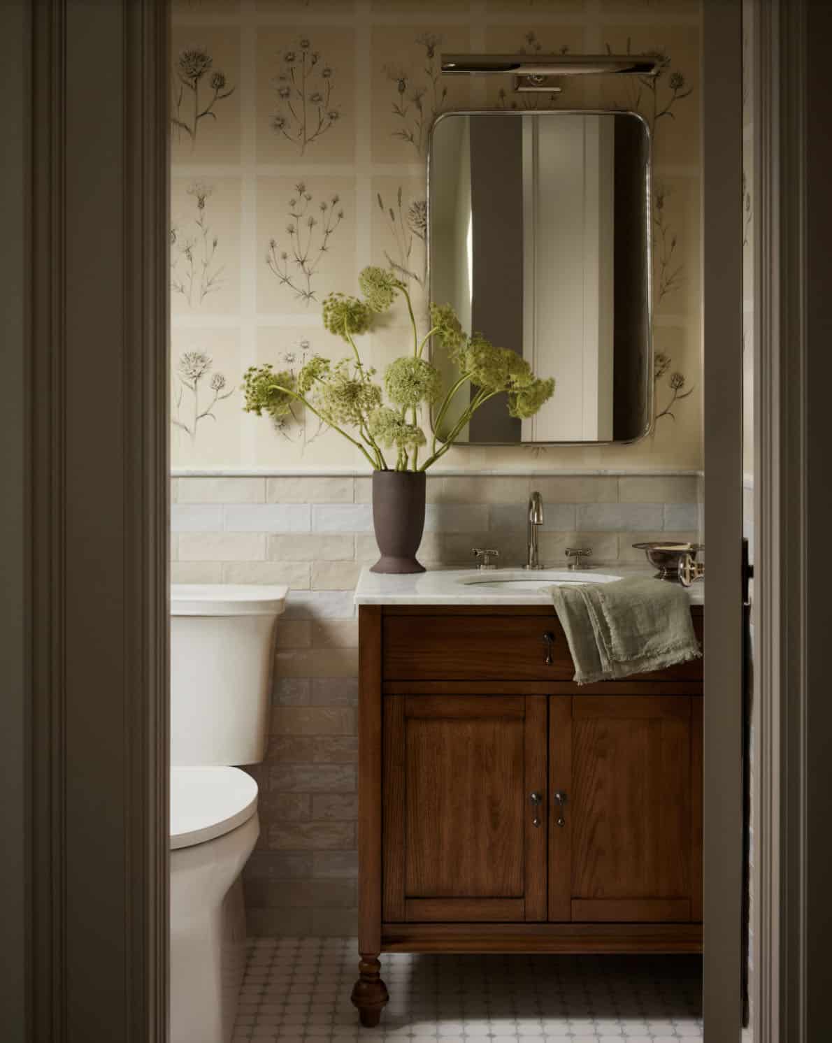 Powder room with floral wallpaper and wood vanity