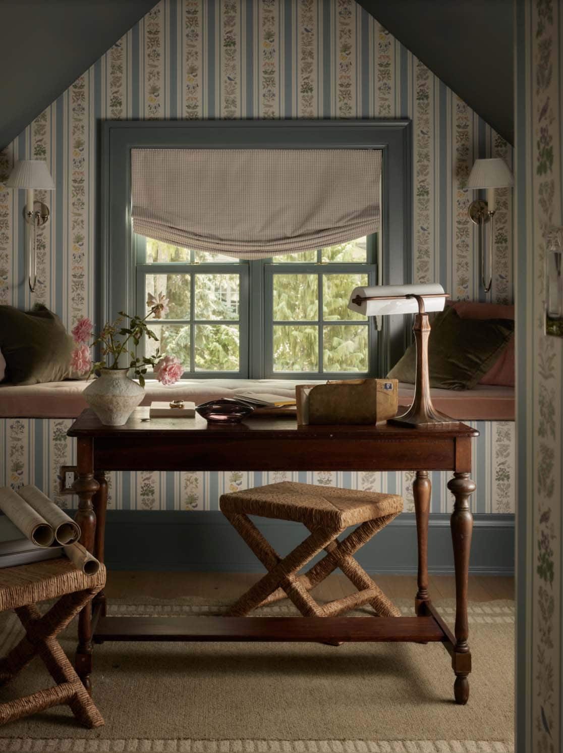 Floral striped wallpaper nook with wood desk and window seat