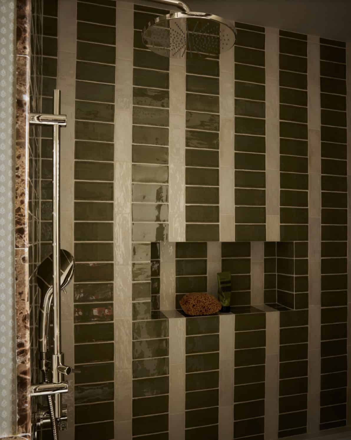 Green and cream striped tile shower with built-in niche
