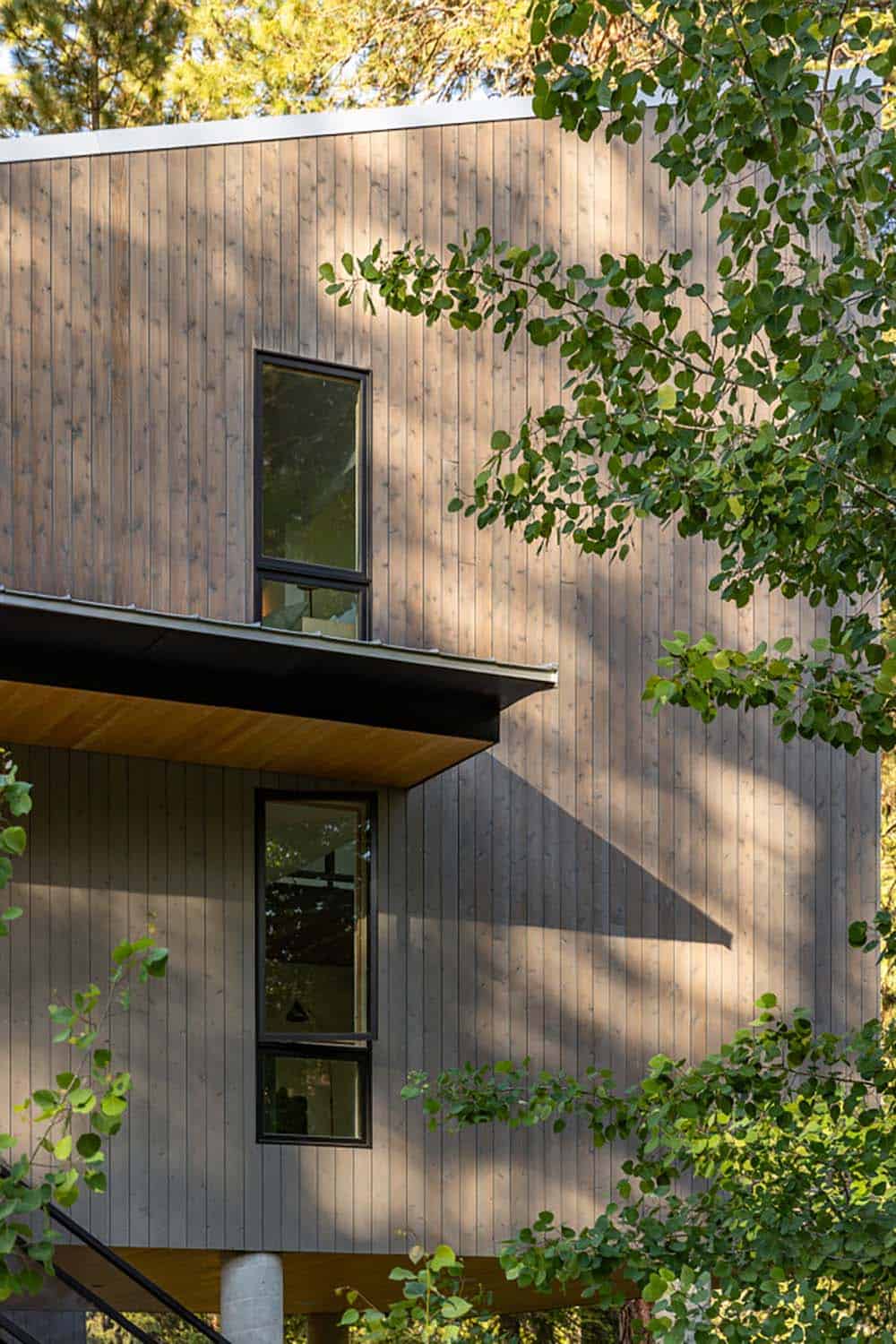 Close-up of vertical cedar siding and shed roof on modern forest cabin